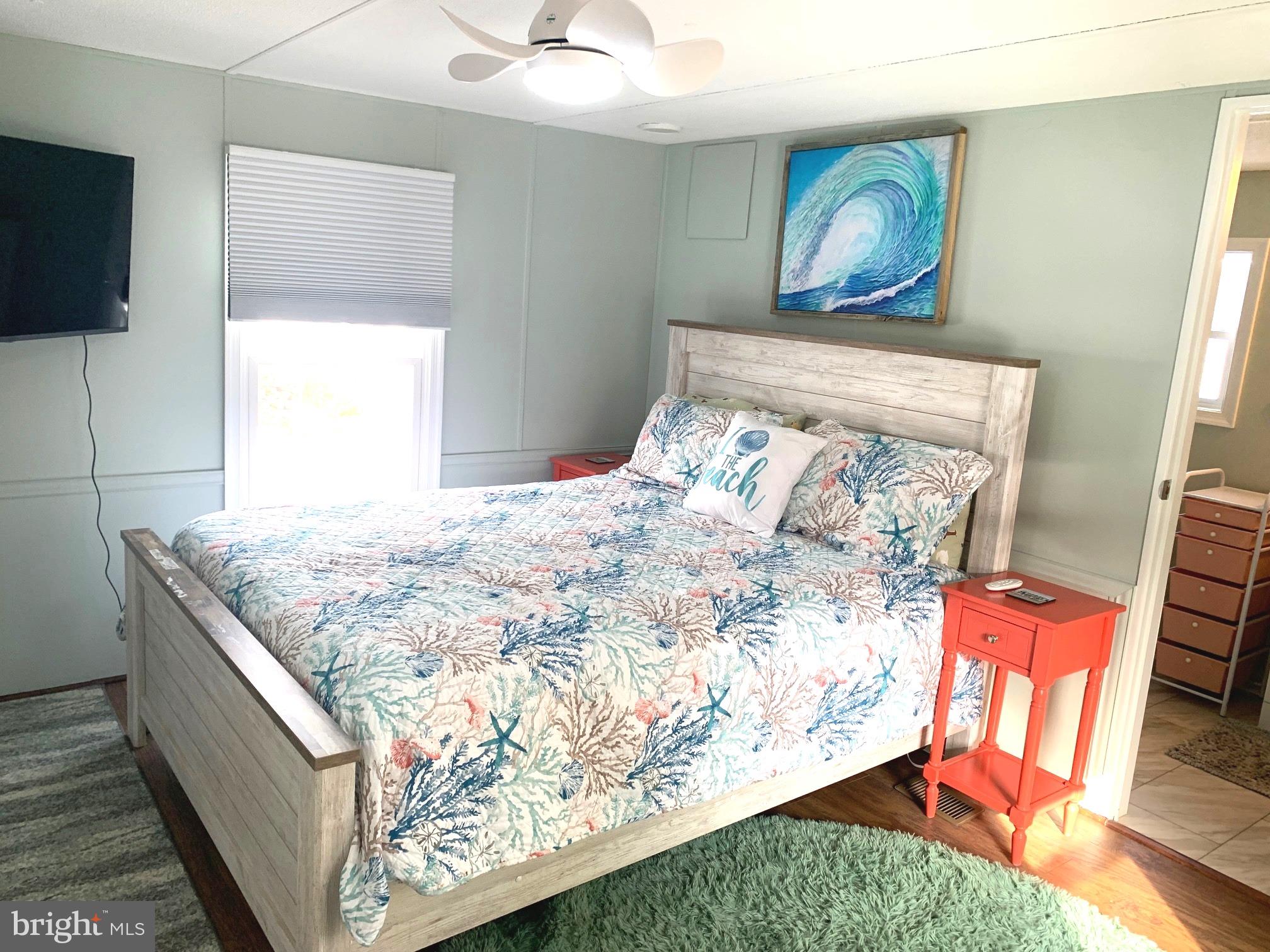 21229 M Street Rehoboth Beach, DE 19971 - Photo 9 of 23 a bed sitting in a bedroom next to a window