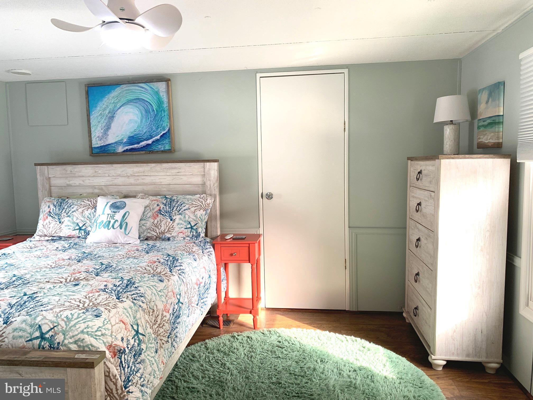 21229 M Street Rehoboth Beach, DE 19971 - Photo 10 of 23 a bedroom with a bed and a painting on the wall