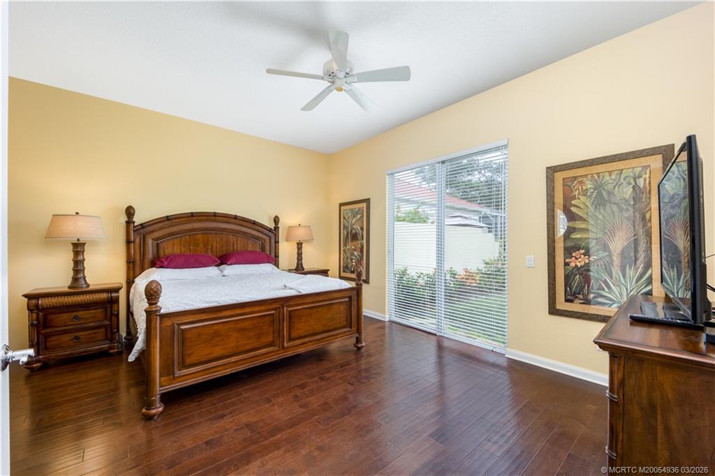 1477 Southwest Eagleglen Place Stuart, FL 34997 - Photo 11 of 36 a bedroom with a large bed and a large window