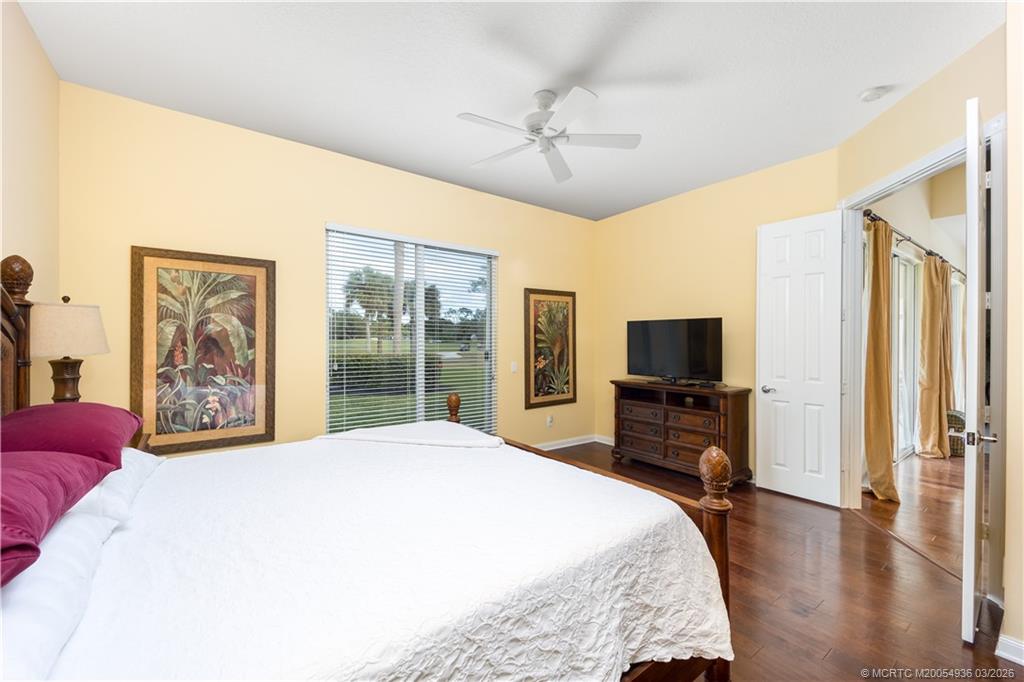 1477 Southwest Eagleglen Place Stuart, FL 34997 - Photo 12 of 36 a bedroom with a bed and a flat screen tv