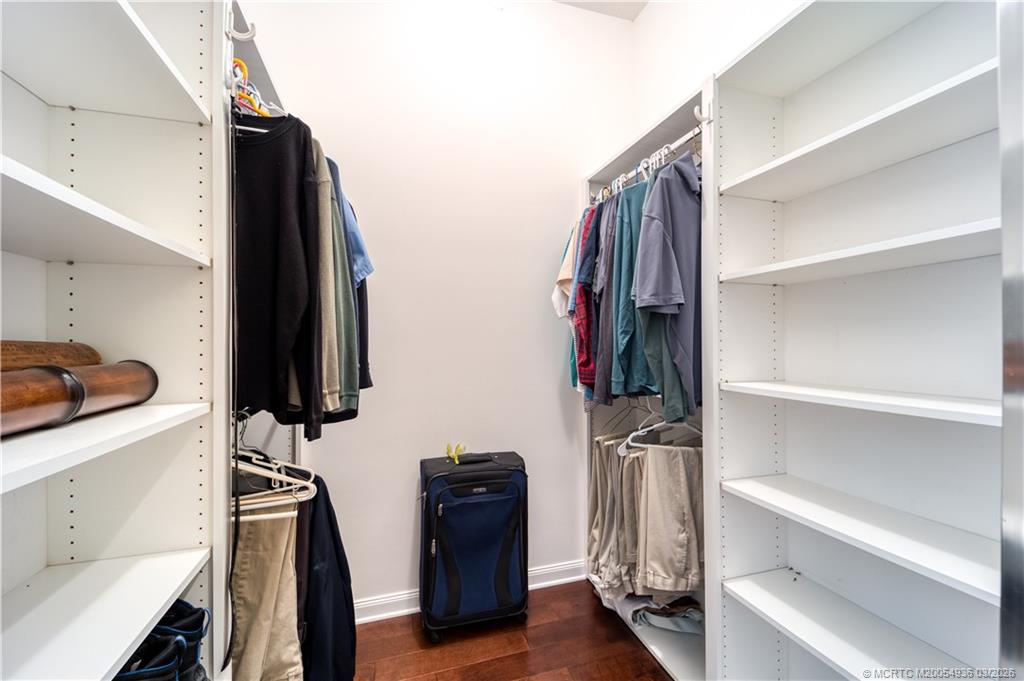 1477 Southwest Eagleglen Place Stuart, FL 34997 - Photo 15 of 36 a view of walk in closet with clothes and shoes