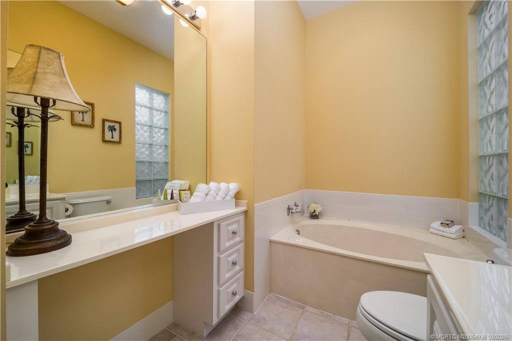1477 Southwest Eagleglen Place Stuart, FL 34997 - Photo 17 of 36 a bathroom with a sink a toilet and shower