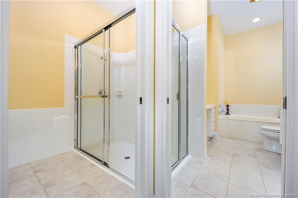 1477 Southwest Eagleglen Place Stuart, FL 34997 - Photo 19 of 36 a bathroom with a shower and a tub