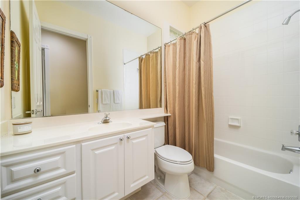 1477 Southwest Eagleglen Place Stuart, FL 34997 - Photo 23 of 36 a bathroom with a sink a toilet and shower