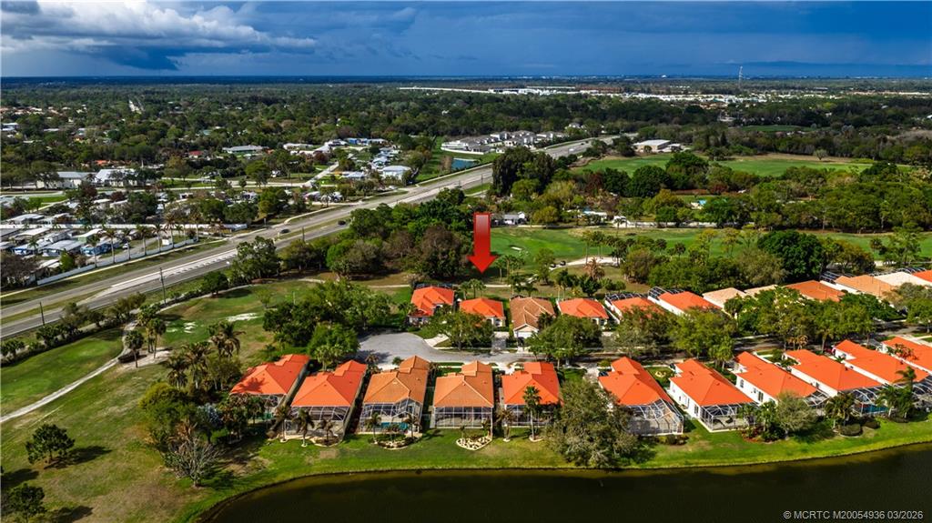 1477 Southwest Eagleglen Place Stuart, FL 34997 - Photo 31 of 36 an aerial view of residential houses with outdoor space and trees