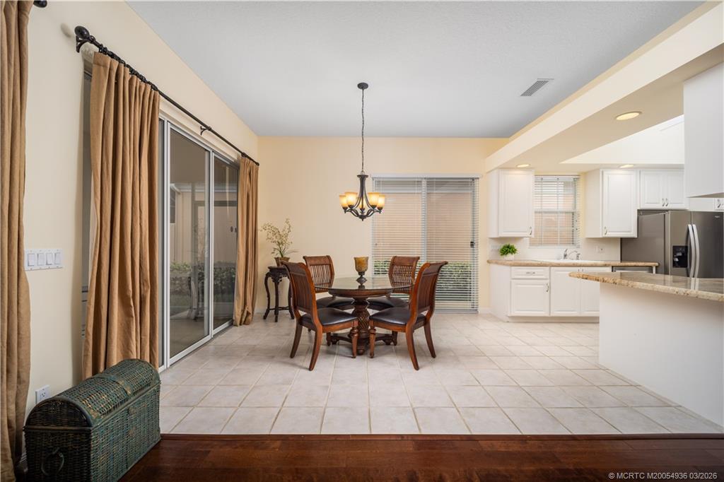 1477 Southwest Eagleglen Place Stuart, FL 34997 - Photo 7 of 36 a view of a dining room with furniture and chandelier