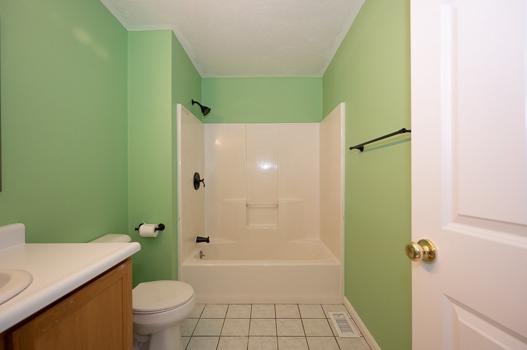 22 Highfield Road, Unit A Charlton, MA 01507 - Photo 19 of 26 a bathroom with a granite countertop bathtub sink vanity mirror and toilet