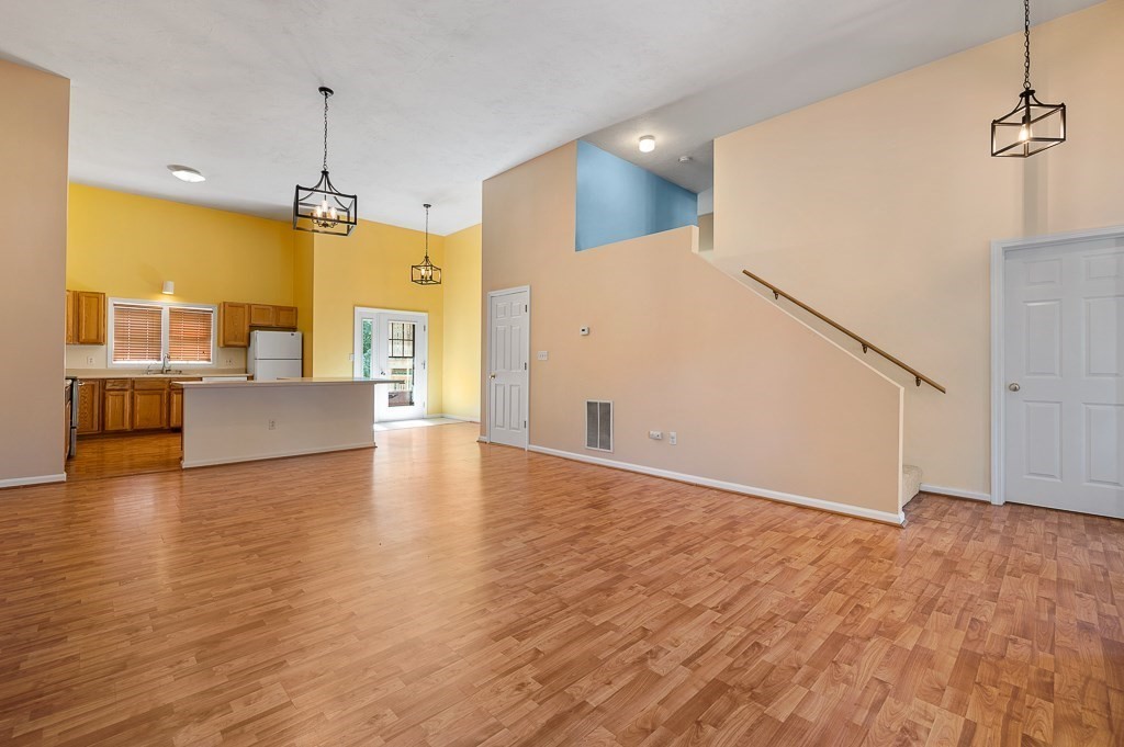 22 Highfield Road, Unit A Charlton, MA 01507 - Photo 5 of 26 a view of a livingroom with wooden floor and a ceiling fan
