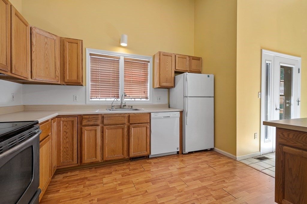 22 Highfield Road, Unit A Charlton, MA 01507 - Photo 7 of 26 a kitchen with a refrigerator sink and cabinets