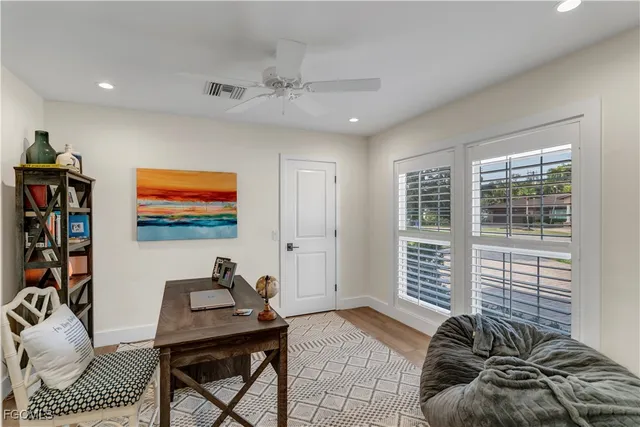a bedroom with furniture and a flat screen tv