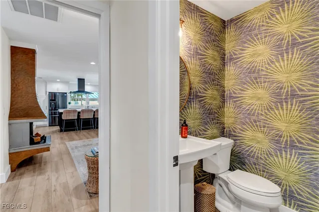 a bathroom with a toilet and a shower curtain