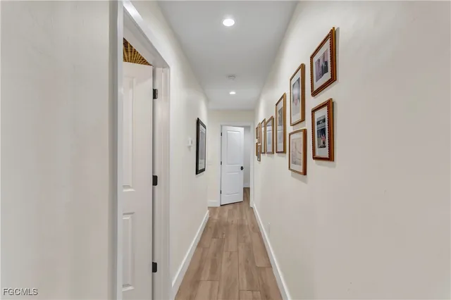 a view of a hallway with wooden floor and closet