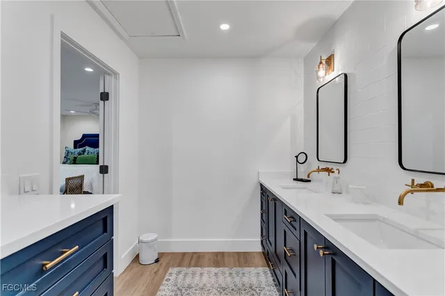 a bathroom with double vanity and a mirror