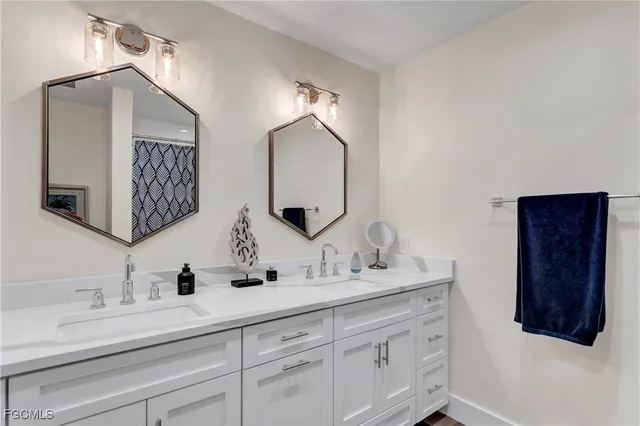a bathroom with a double vanity sink and a mirror