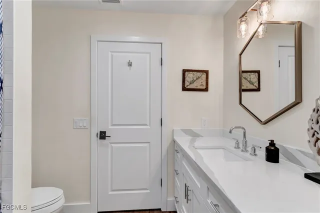 a bathroom with a sink toilet and vanity