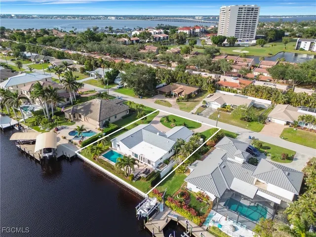 an aerial view of a house a yard swimming pool and outdoor seating