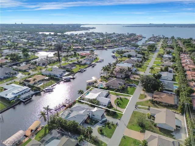an aerial view of house with yard and ocean view