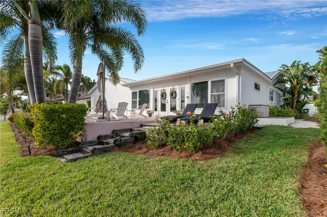 a view of house with outdoor space and garden