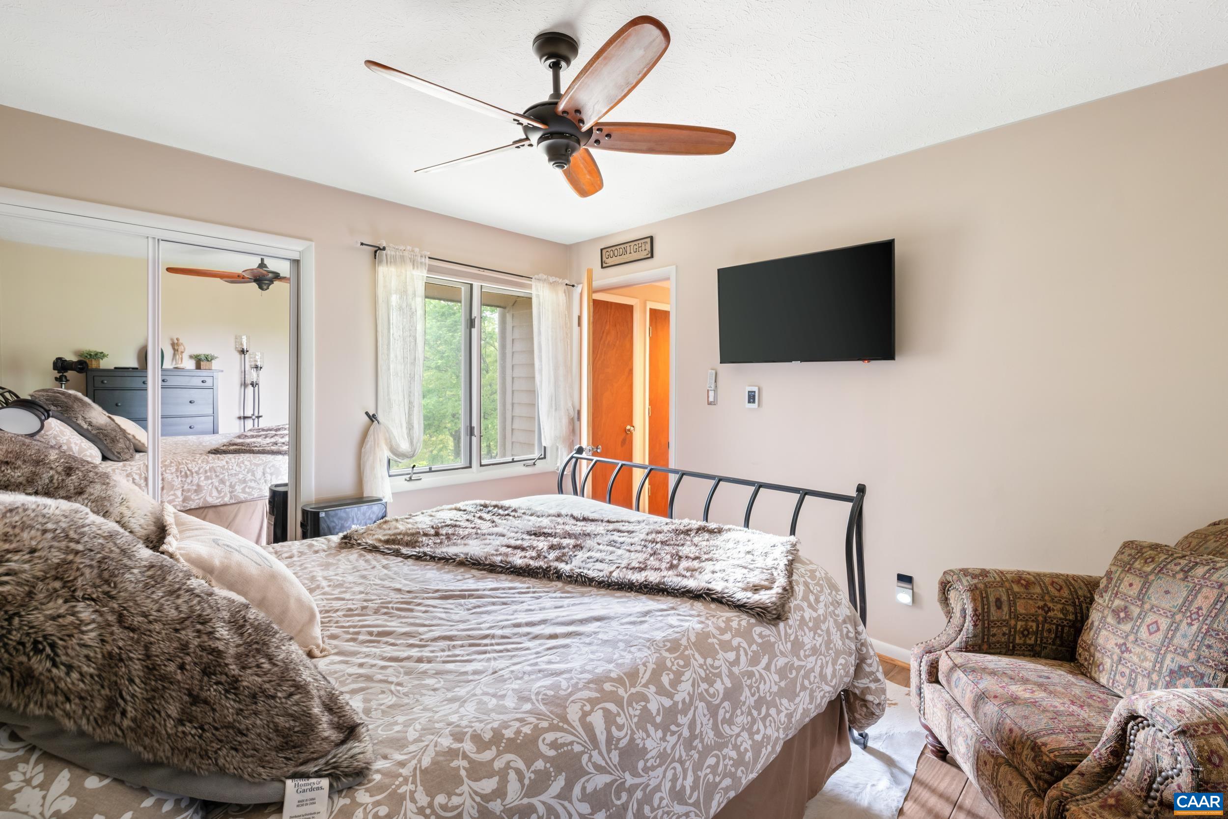 2225 Tanners Ridge Roseland, VA 22967 - Photo 11 of 26 a bedroom with a bed a flat screen tv and a couch