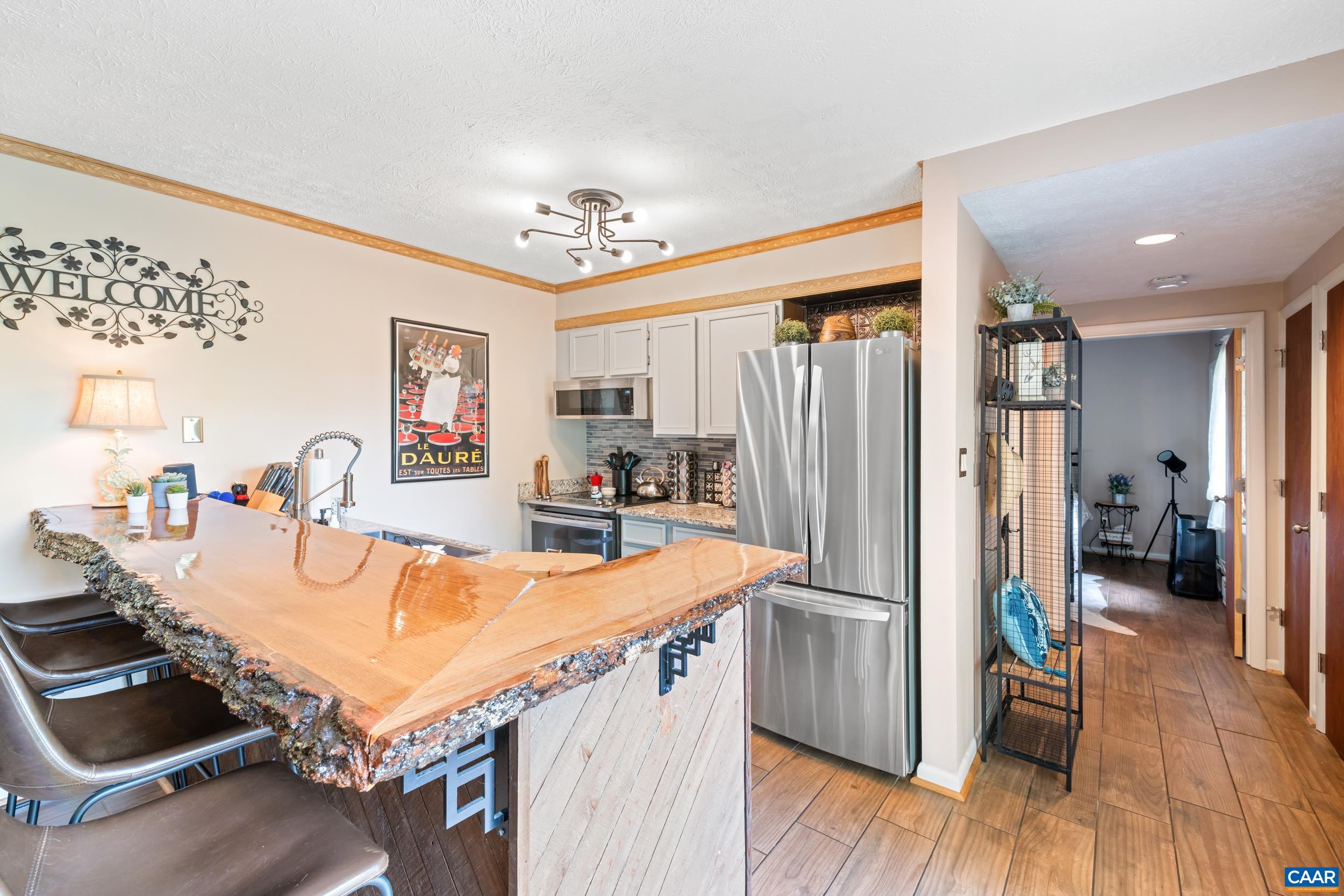 2225 Tanners Ridge Roseland, VA 22967 - Photo 2 of 26 a kitchen with stainless steel appliances refrigerator dining table and chairs