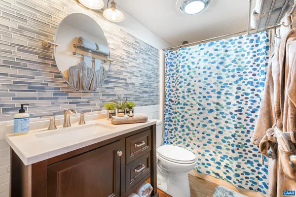 a bathroom with a sink toilet and shower