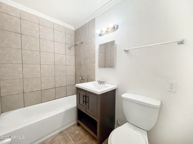 a view of a kitchen with white cabinets