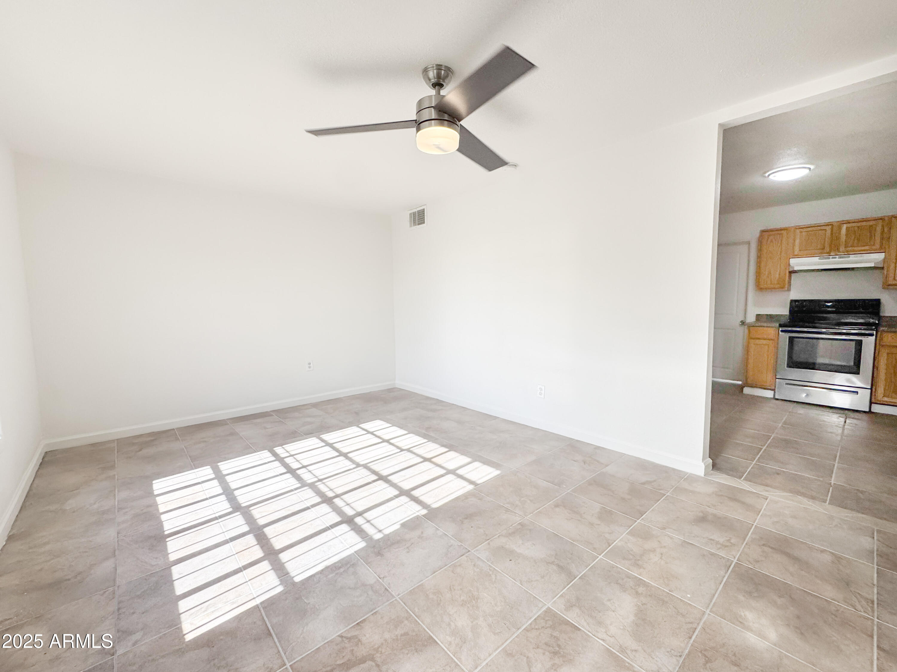 3422 East Culver Street Phoenix, AZ 85008 - Photo 5 of 25 an empty room with windows and ceiling fan view