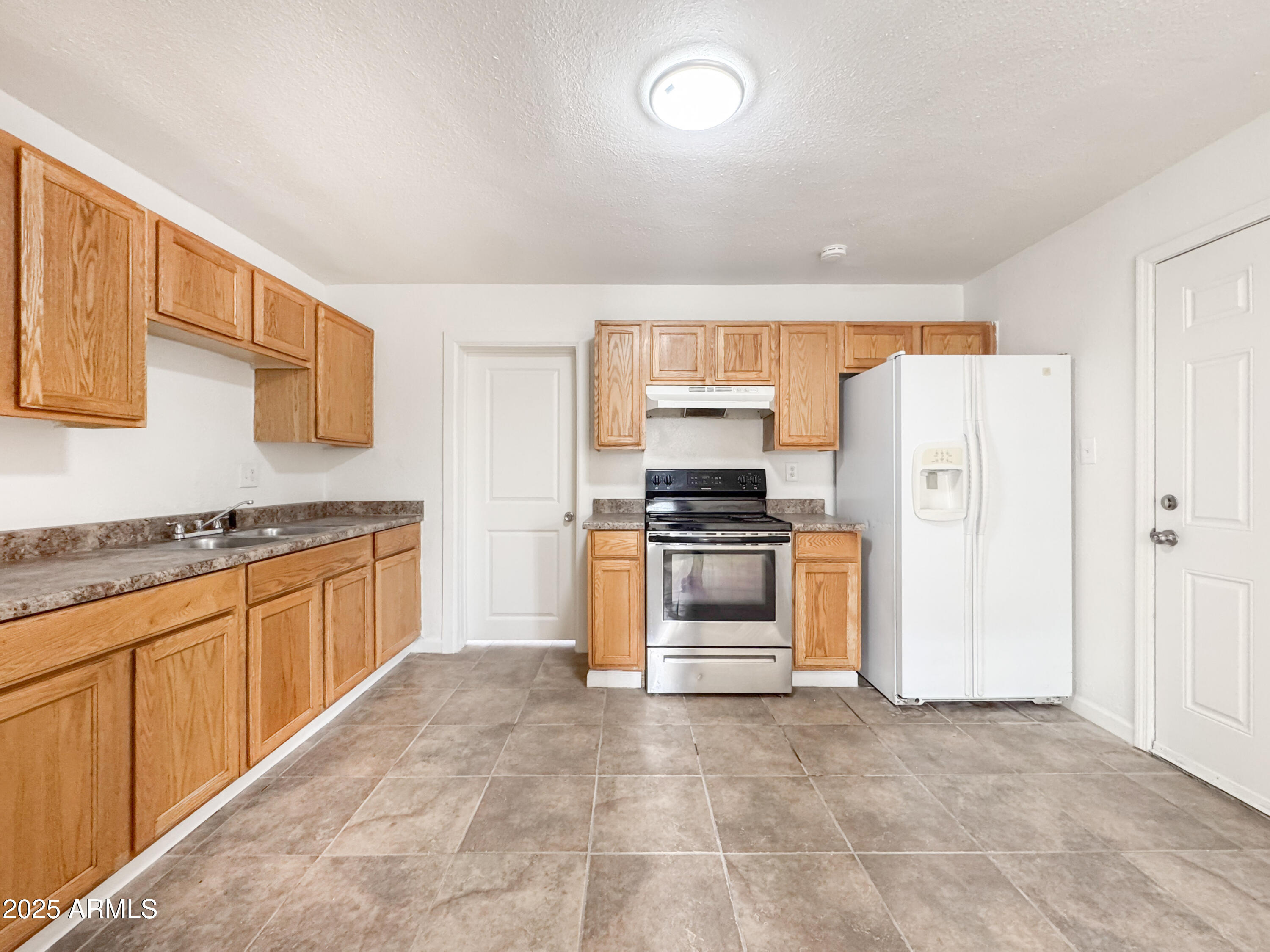 3422 East Culver Street Phoenix, AZ 85008 - Photo 8 of 25 a kitchen with stainless steel appliances a refrigerator stove and sink
