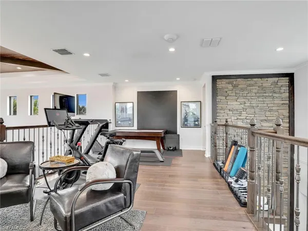 a living room with furniture a flat screen tv and a floor to ceiling window