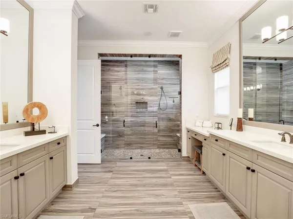 a bathroom with a sink vanity granite tub and shower