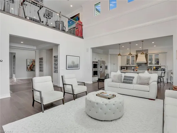 a living room with furniture and kitchen view