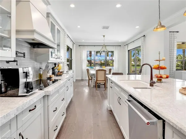 a kitchen with counter top space and wooden floor