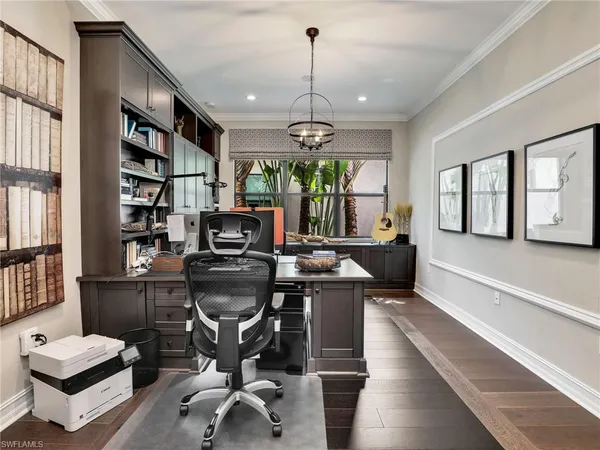 a view of a workspace with furniture and a window