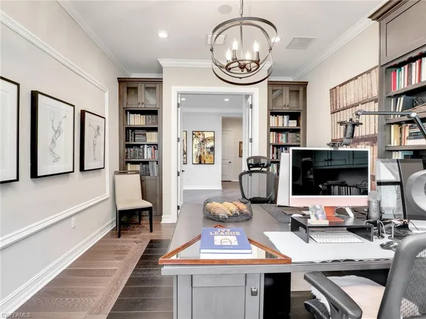 a living room with furniture a rug and a bookshelf