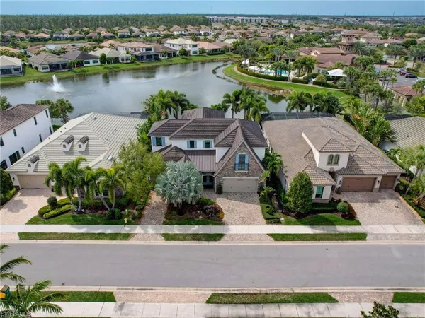 an aerial view of a house with outdoor space and lake view