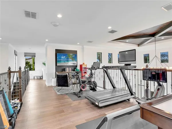 a view of a livingroom with furniture wooden floor and windows