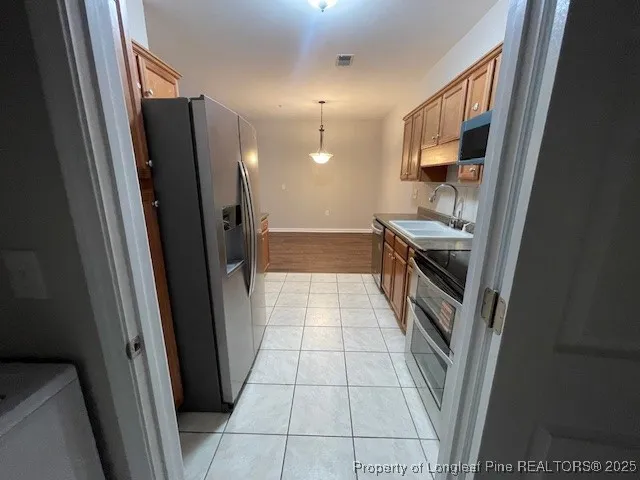 a bathroom with a sink a toilet a mirror and shower