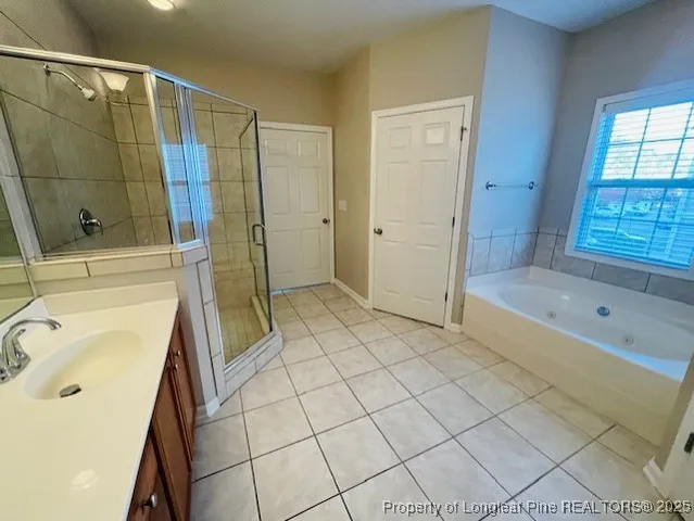 a bathroom with a tub shower and sink