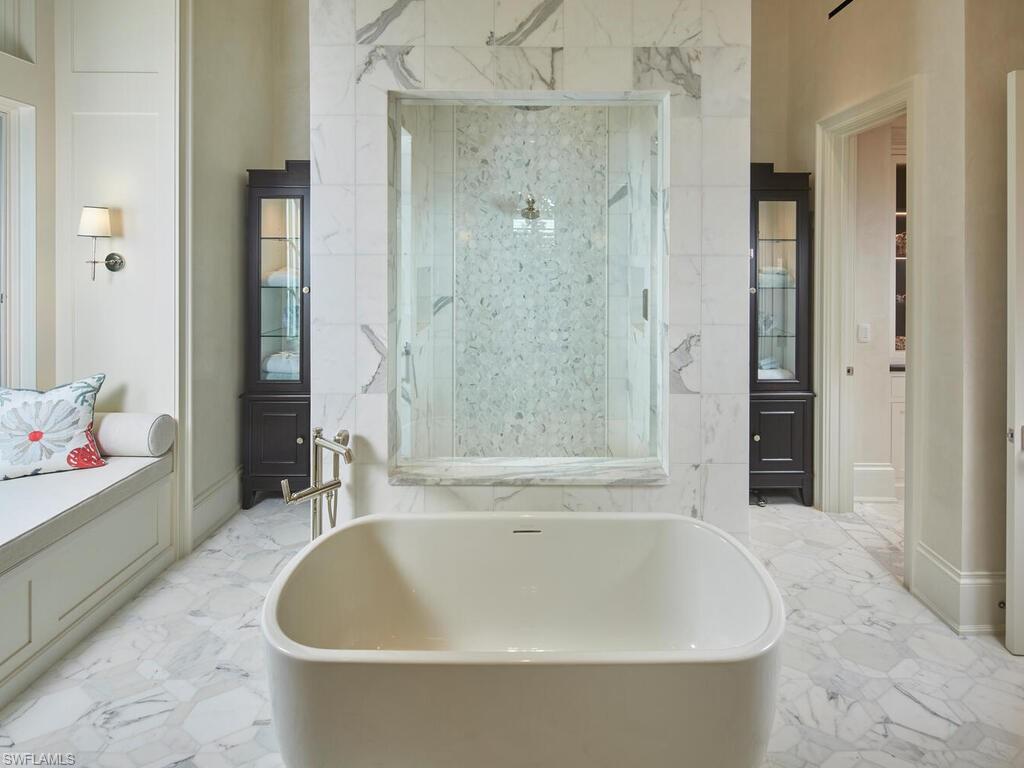 167 4th Street North Naples, FL 34102 - Photo 12 of 33 a white bath tub sitting next to a bathroom