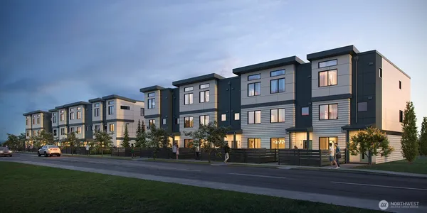 a front view of a residential apartment building with a yard