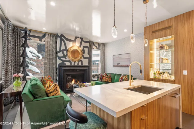 a kitchen with a table chairs and a fireplace