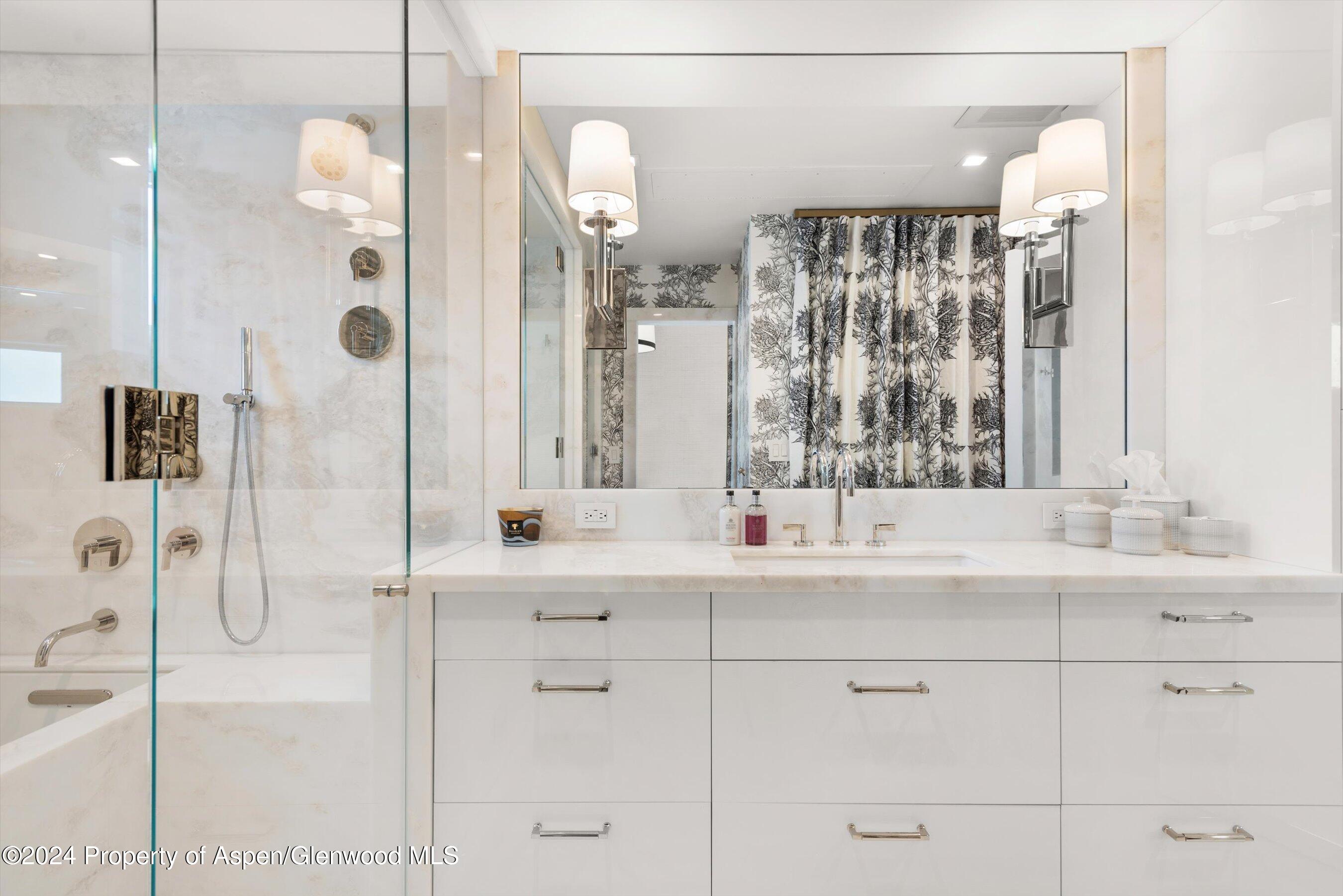 434 East Main Street, Unit 203 Aspen, CO 81611 - Photo 17 of 22 a bathroom with a double vanity sink mirror and shower
