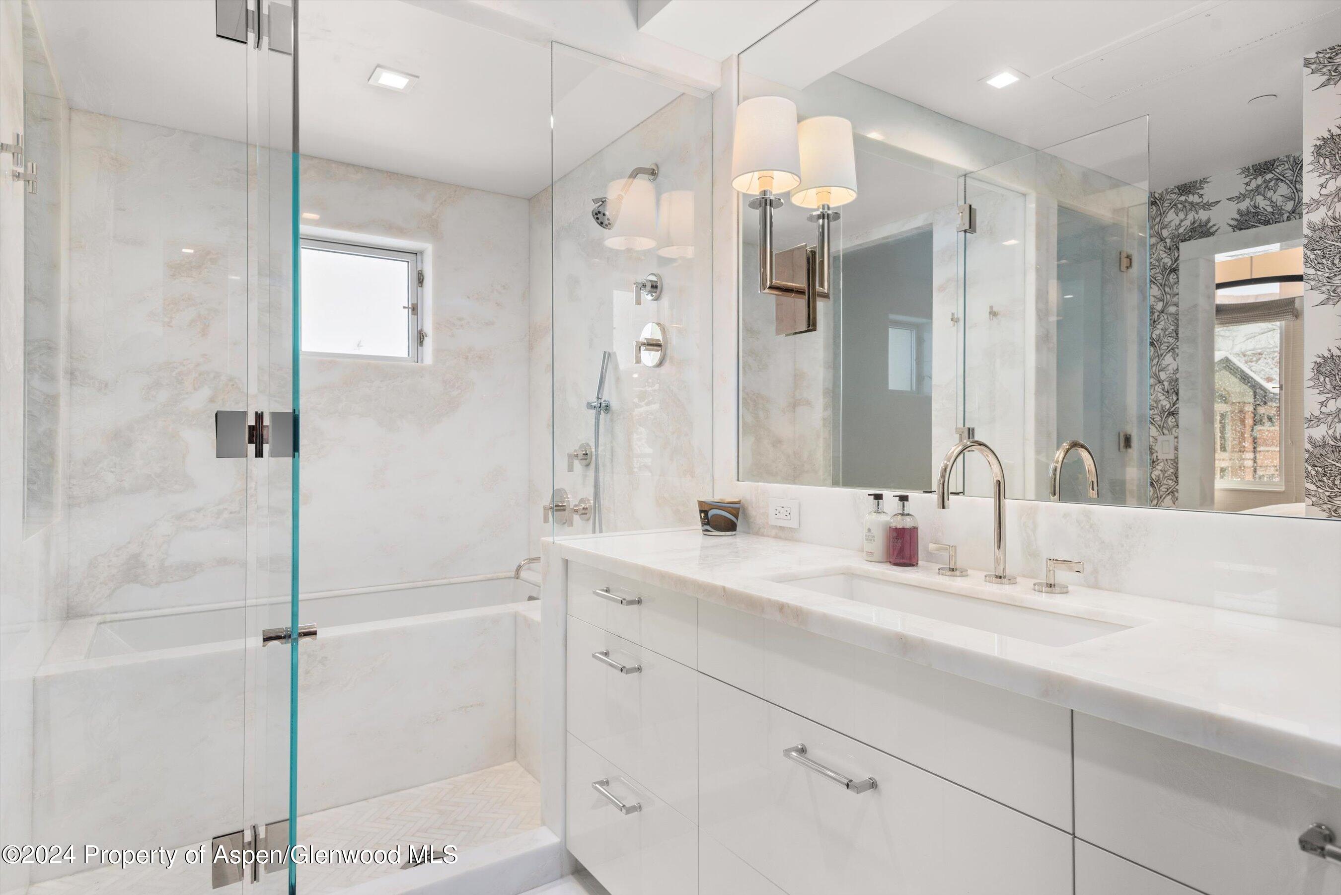 434 East Main Street, Unit 203 Aspen, CO 81611 - Photo 18 of 22 a bathroom with a double vanity sink mirror and shower