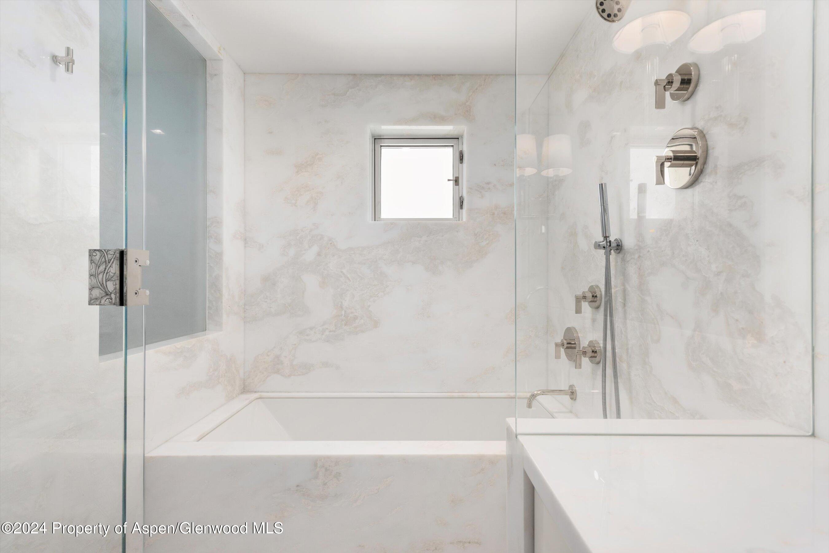 434 East Main Street, Unit 203 Aspen, CO 81611 - Photo 19 of 22 a bathroom with a bathtub and a shower