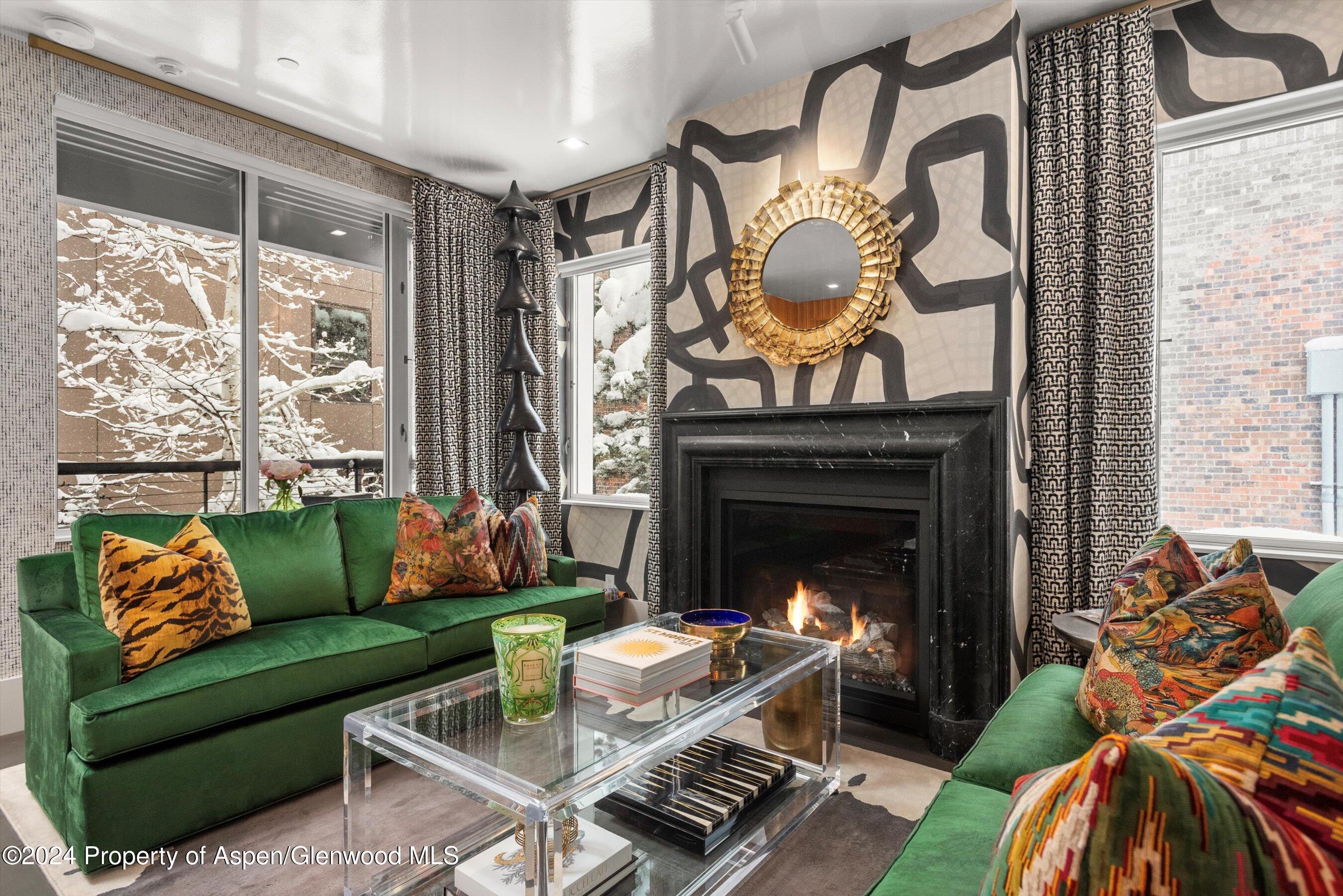 434 East Main Street, Unit 203 Aspen, CO 81611 - Photo 2 of 22 a living room with furniture and a fireplace