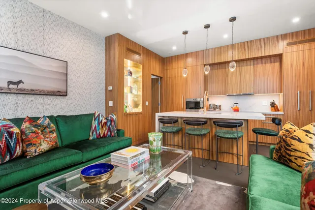 a kitchen with a table chairs stove and kitchen view