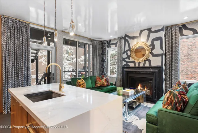 a living room with fireplace furniture and a fireplace