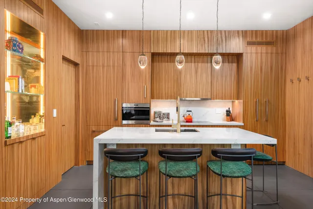 a kitchen with a table chairs sink and cabinets