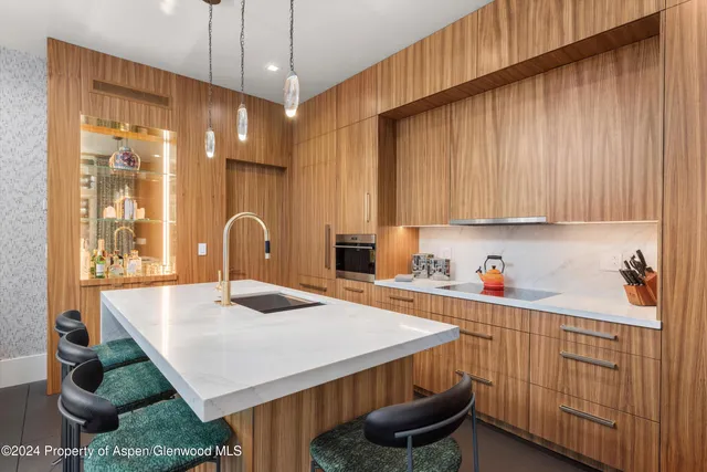 a kitchen with granite countertop a sink a stove and cabinets