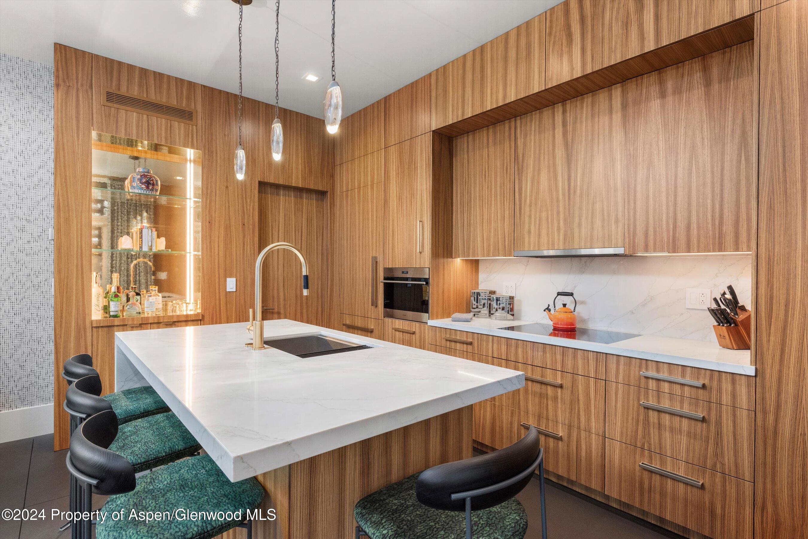 434 East Main Street, Unit 203 Aspen, CO 81611 - Photo 9 of 22 a kitchen with granite countertop a sink a stove and cabinets